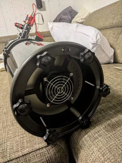 Move the primary mirror towards the focuser to achieve focus with a camera on a Newtonian telescope.